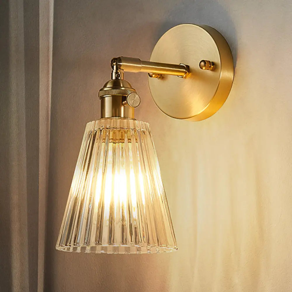 Clear Textured Glass Wall Sconce With Brass Accents For Industrial Dining Room Lighting