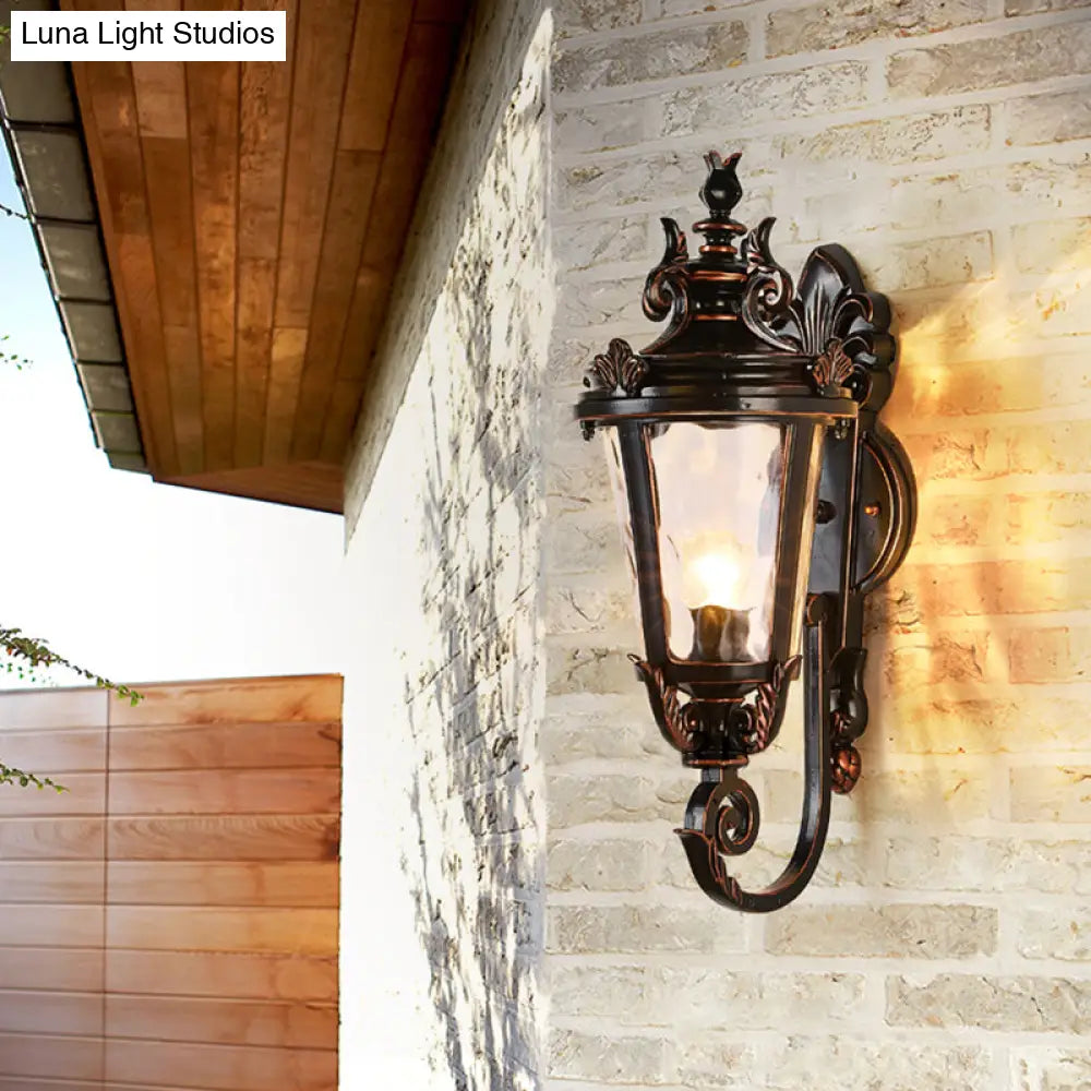 Clear Water Glass Outdoor Wall Sconce: Scrolled Arm 1-Light Black & Gold Lodge Lighting