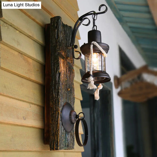 Coastal Black Kerosene Sconce With Clear Glass Bulb And Wooden Backplate For Outdoor Lighting