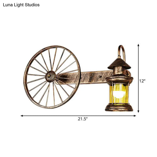 Coastal Brass Amber Glass Wall Sconce With Wagon Wheel Deco