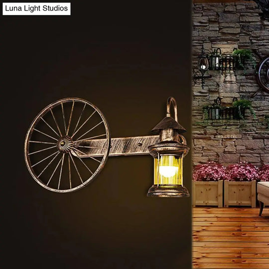 Coastal Brass Amber Glass Wall Sconce With Wagon Wheel Deco