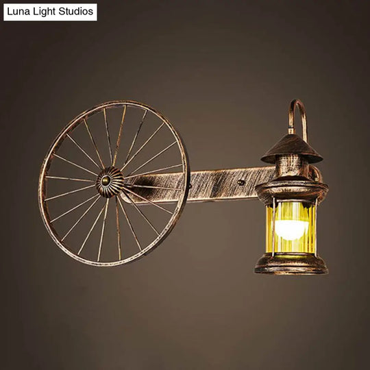 Coastal Brass Amber Glass Wall Sconce With Wagon Wheel Deco