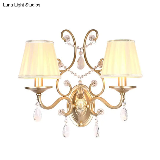 Contemporary Crystal Wall Sconce With Curved Arm And Brass Finish