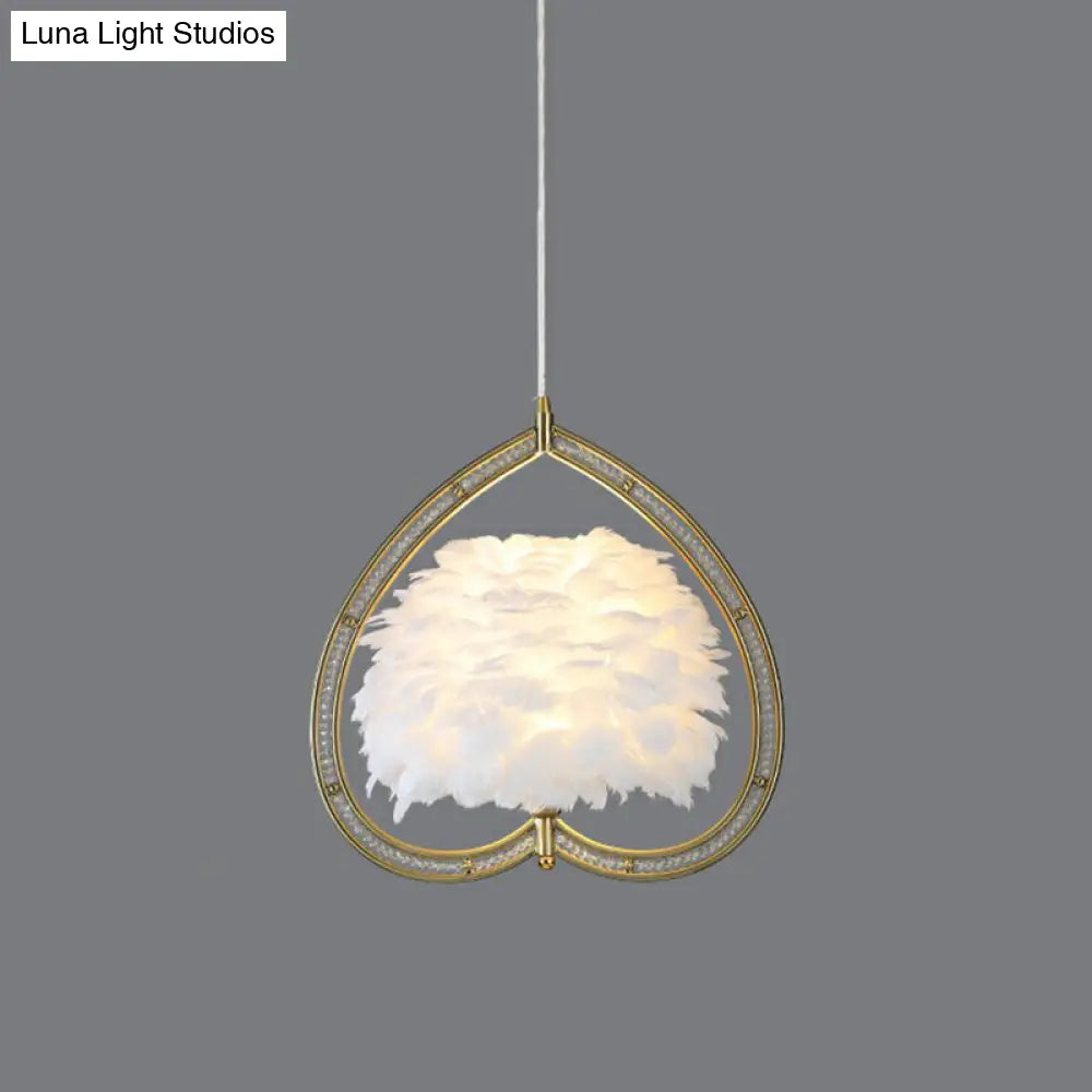 Contemporary Gold Pendant Light With Metallic Heart Suspension And Decorative Feather