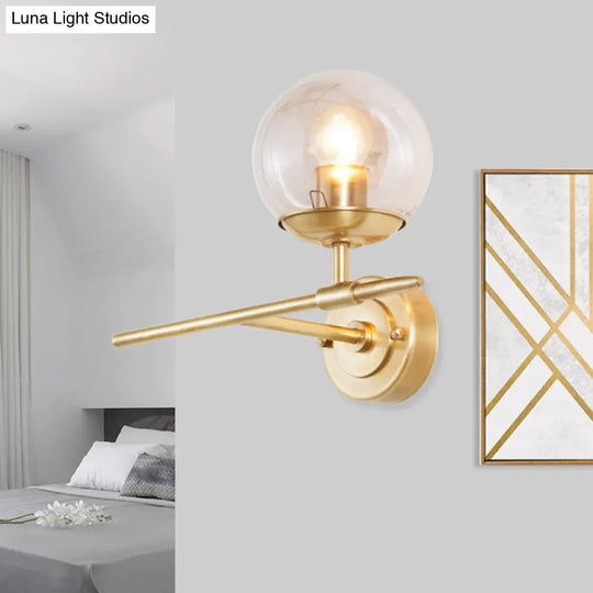 Contemporary Hand Blown Glass Wall Light With Brass Globe And Crossed Arm