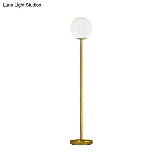 Contemporary Milky Glass Sphere Floor Light With Brass Finish - Ideal For Bedroom Reading