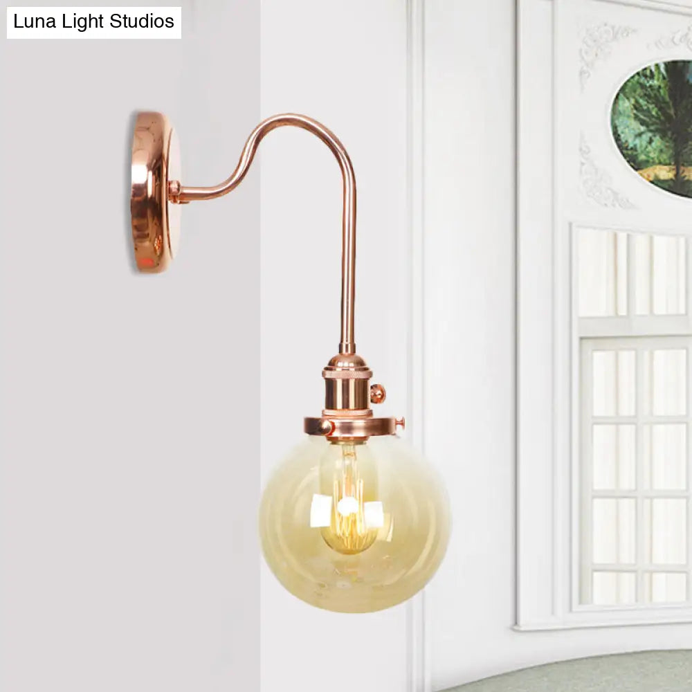 Copper Vintage Globe Wall Sconce With Curved Arm And Clear/Amber Glass - 1 Light