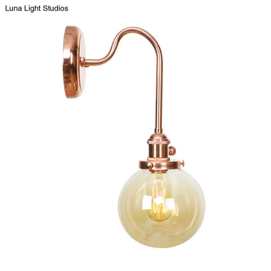 Copper Vintage Globe Wall Sconce With Curved Arm And Clear/Amber Glass - 1 Light