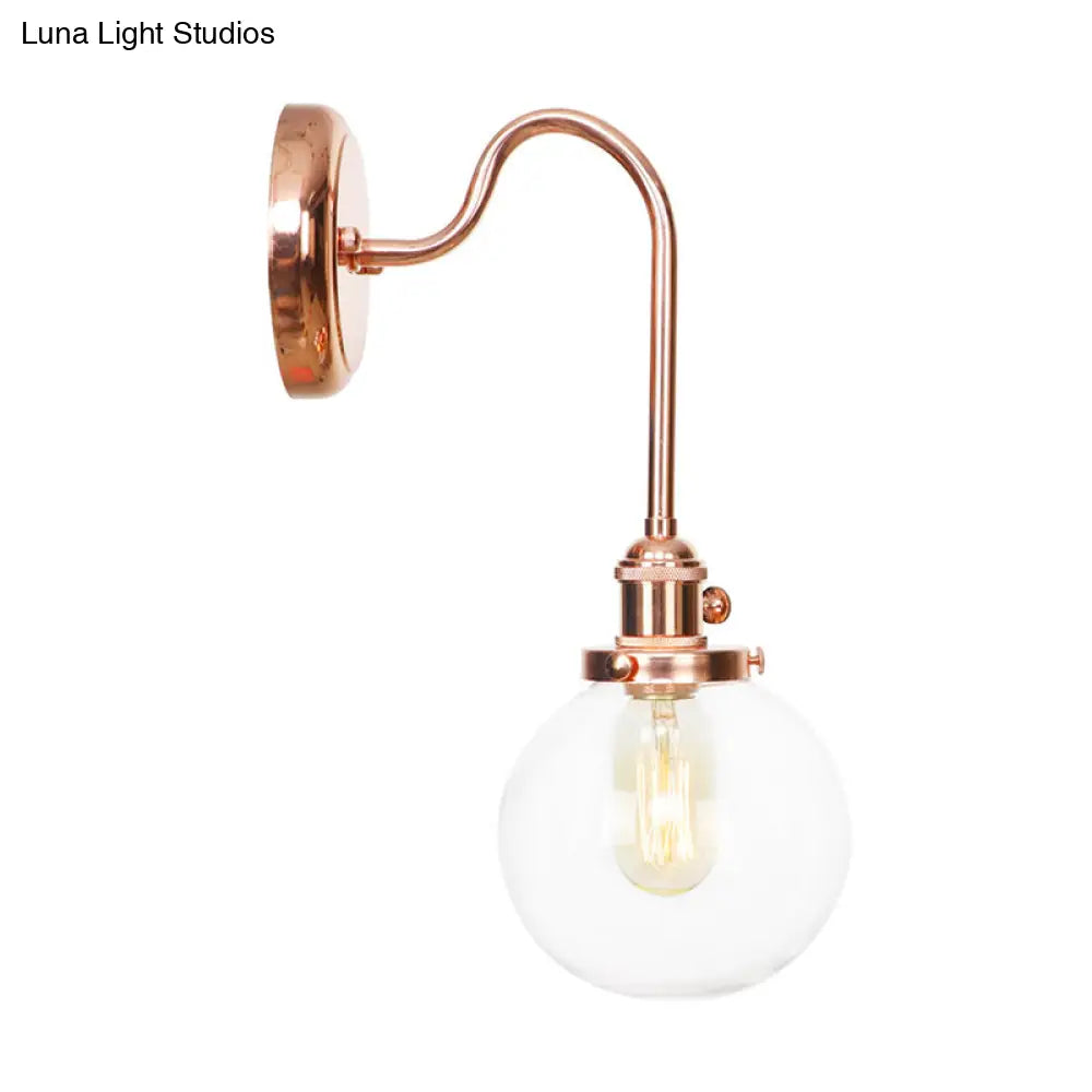 Copper Vintage Globe Wall Sconce With Curved Arm And Clear/Amber Glass - 1 Light