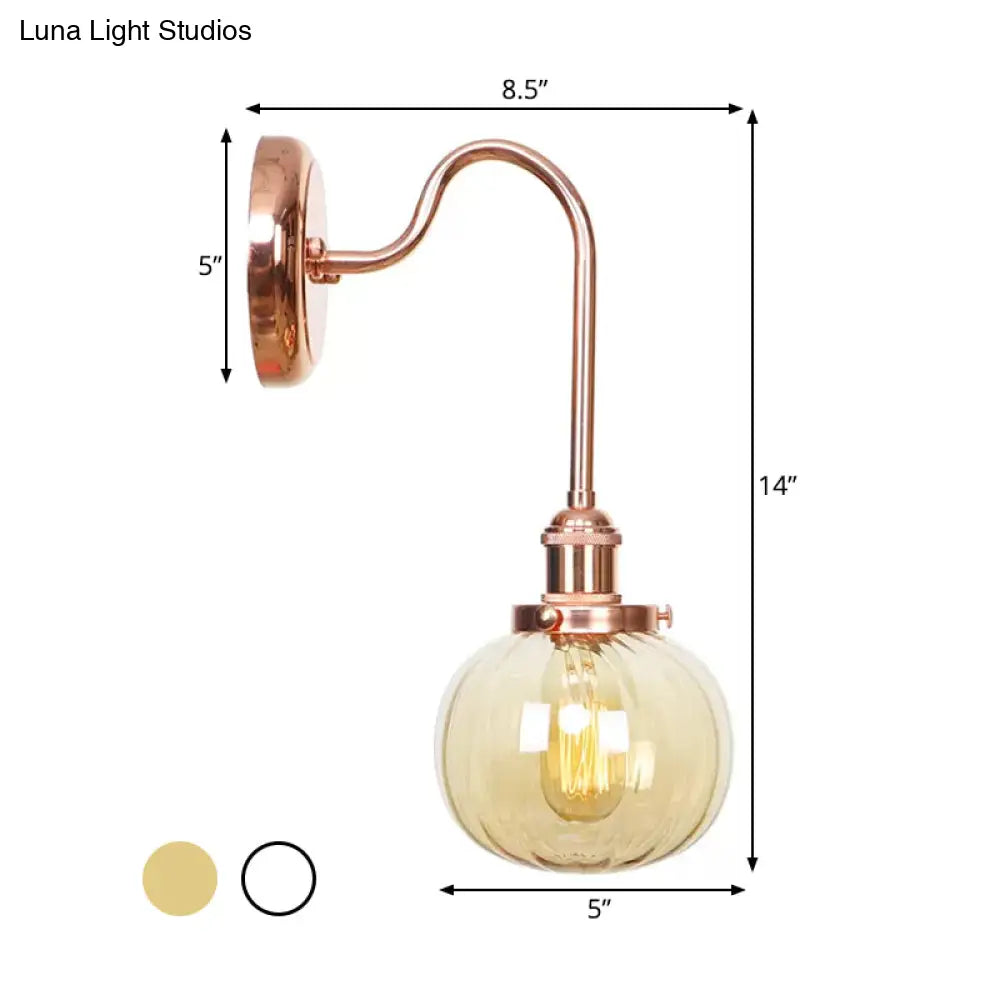 Copper Vintage Globe Wall Sconce With Curved Arm And Clear/Amber Glass - 1 Light