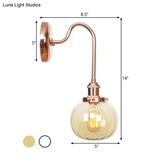 Copper Vintage Globe Wall Sconce With Curved Arm And Clear/Amber Glass - 1 Light