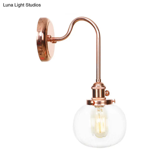 Copper Vintage Globe Wall Sconce With Curved Arm And Clear/Amber Glass - 1 Light