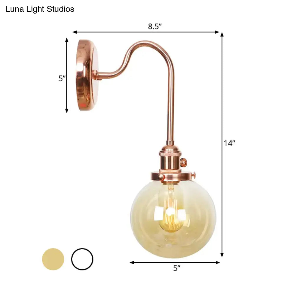 Copper Vintage Globe Wall Sconce With Curved Arm And Clear/Amber Glass - 1 Light