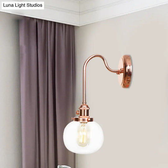 Copper Vintage Globe Wall Sconce With Curved Arm And Clear/Amber Glass - 1 Light