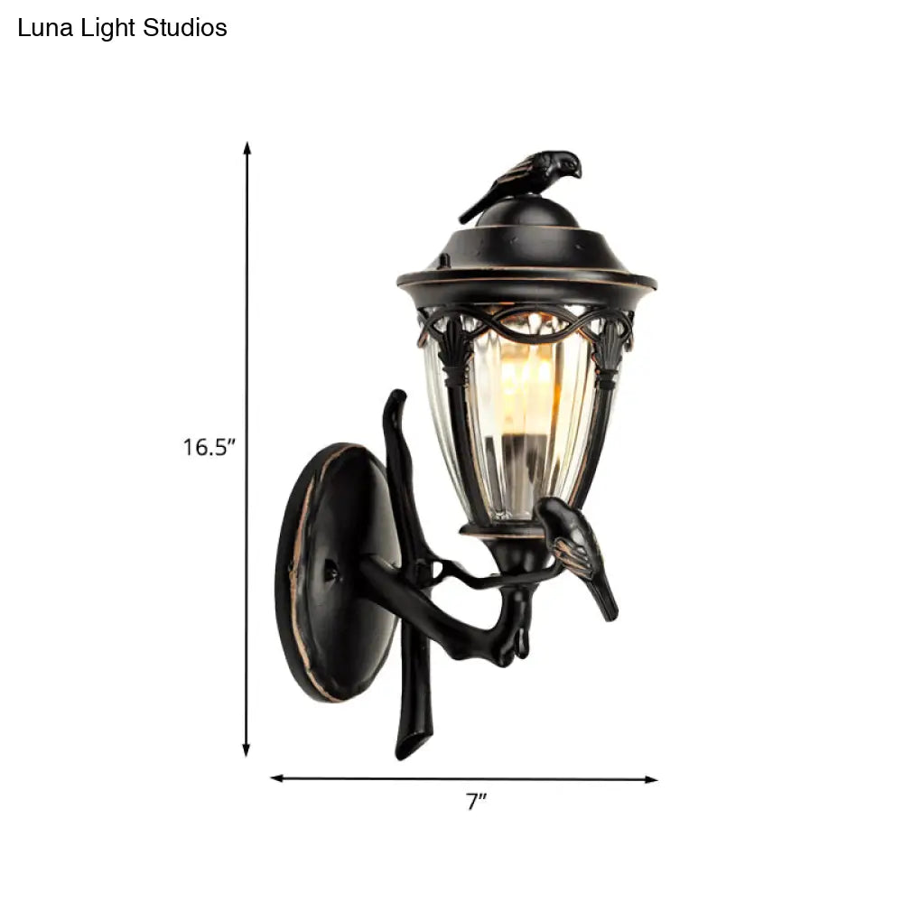 Countryside 1-Light Black Clear Glass Urn Wall Sconce With Bird Decor Perfect For Patio Lighting