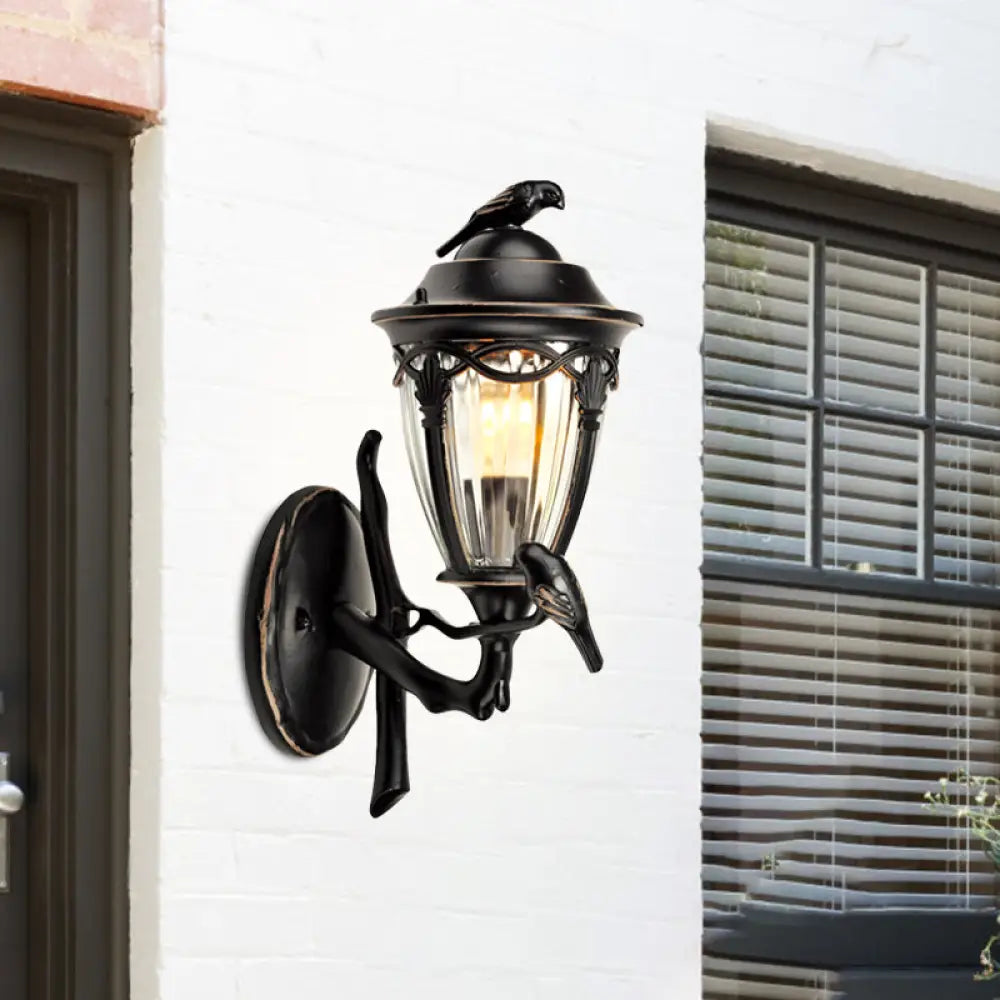 Countryside 1-Light Black Clear Glass Urn Wall Sconce With Bird Decor Perfect For Patio Lighting