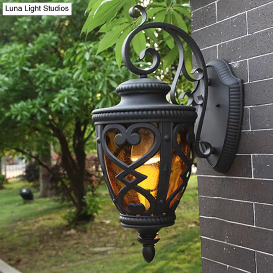 Courtyard Wall Light Fixture: Elegant Urn Shape One Amber Glass Black Mount