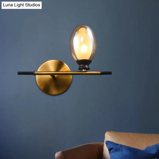 Elegant Clear/Amber Glass Egg Shape Wall Light - Minimalist 1 Brass Sconce