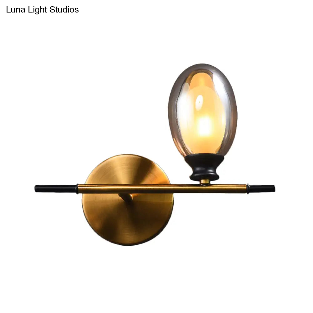 Elegant Clear/Amber Glass Egg Shape Wall Light - Minimalist 1 Brass Sconce