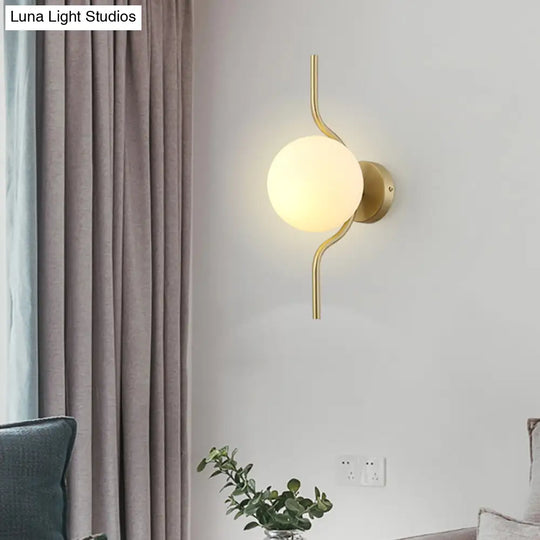 Globe White Glass Wall Mount Sconce Light With Elegant Gold Arm And Base