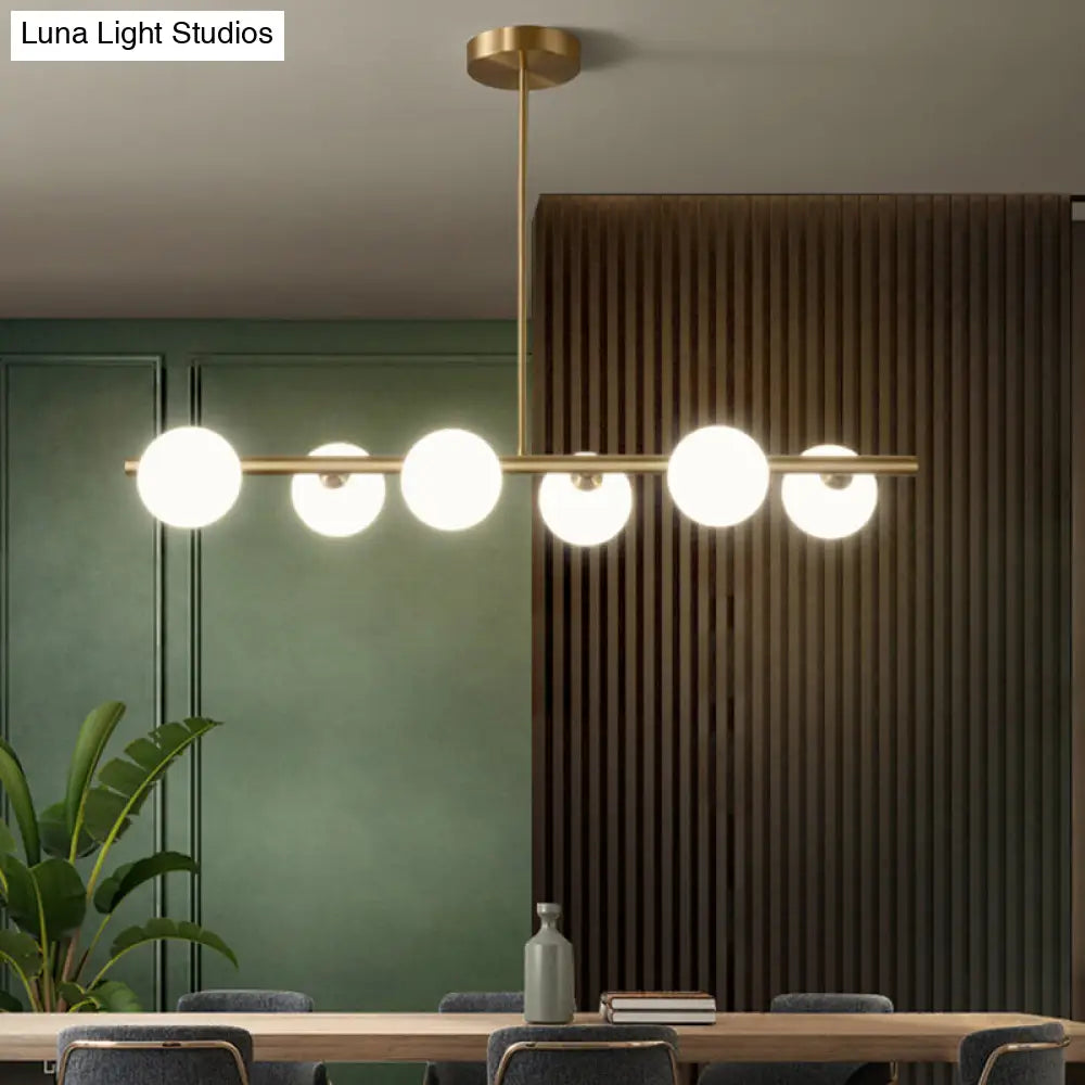 Linear Gold Pendant Light With Spherical Glass For Modern Minimalist Dining Table