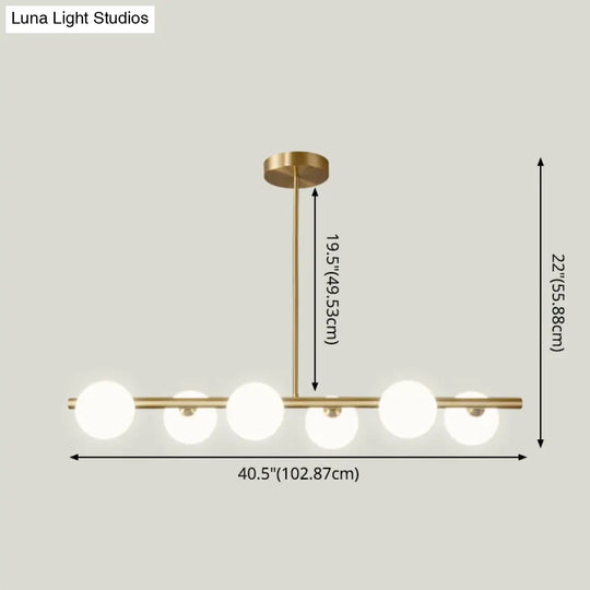 Linear Gold Pendant Light With Spherical Glass For Modern Minimalist Dining Table