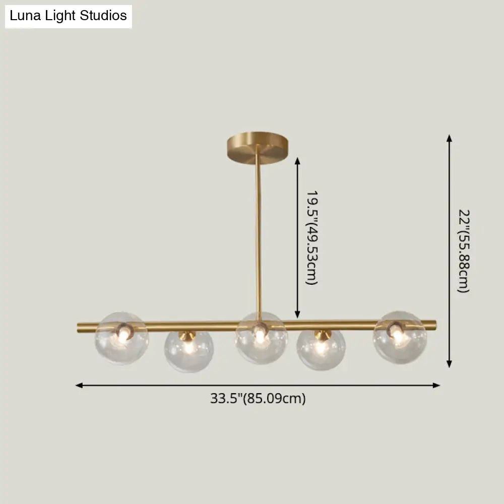 Linear Gold Pendant Light With Spherical Glass For Modern Minimalist Dining Table