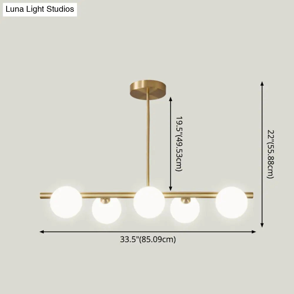 Linear Gold Pendant Light With Spherical Glass For Modern Minimalist Dining Table