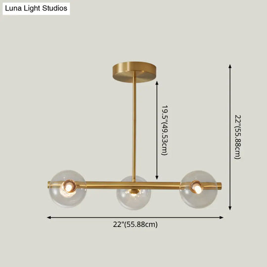 Linear Gold Pendant Light With Spherical Glass For Modern Minimalist Dining Table