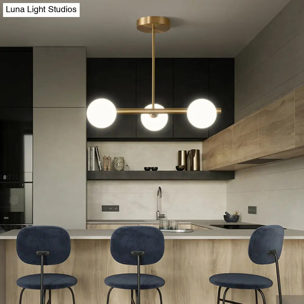 Linear Gold Pendant Light With Spherical Glass For Modern Minimalist Dining Table