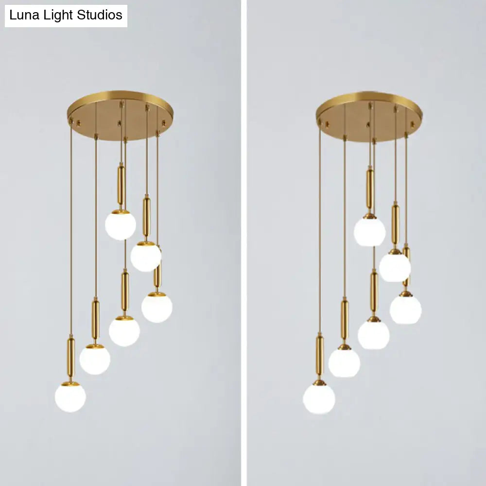 Gold Multi Hanging Stairway Light With Minimalist White Glass Ball Pendant