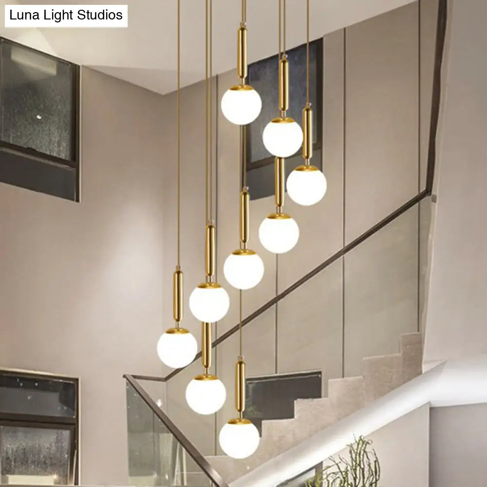 Gold Multi Hanging Stairway Light With Minimalist White Glass Ball Pendant