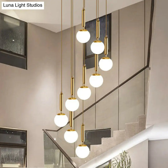 Gold Multi Hanging Stairway Light With Minimalist White Glass Ball Pendant