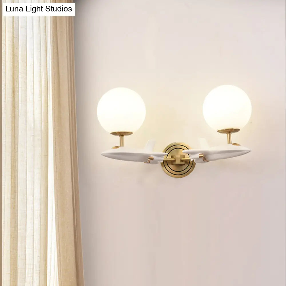 Gold Spaceship Wall Sconce With Cream Glass Globe For Kids Room - 1/2 Bulb Fixture In White &