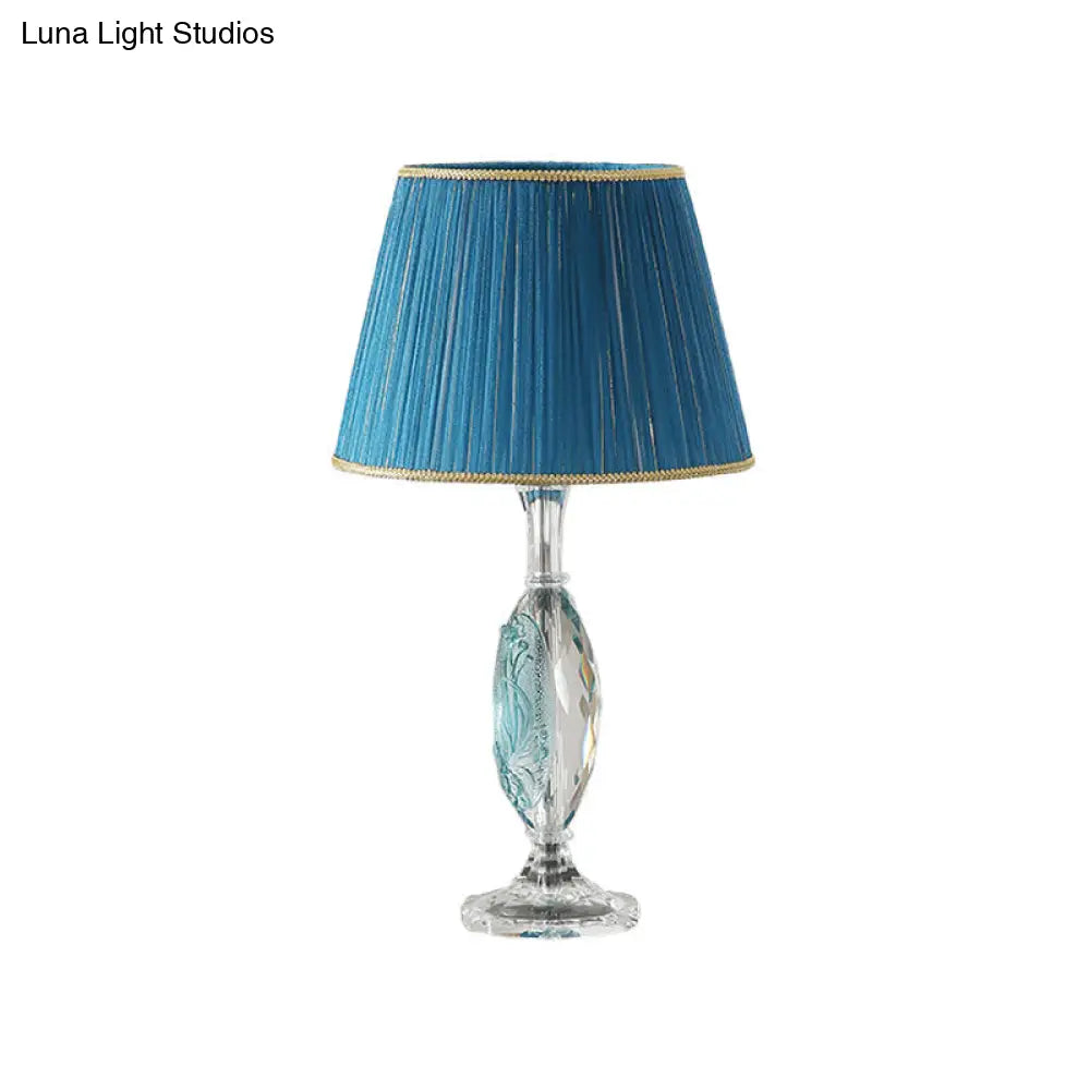 Traditional Clear Crystal Night Light With Blue Fabric Shade And Oblong Base

This Revised Title