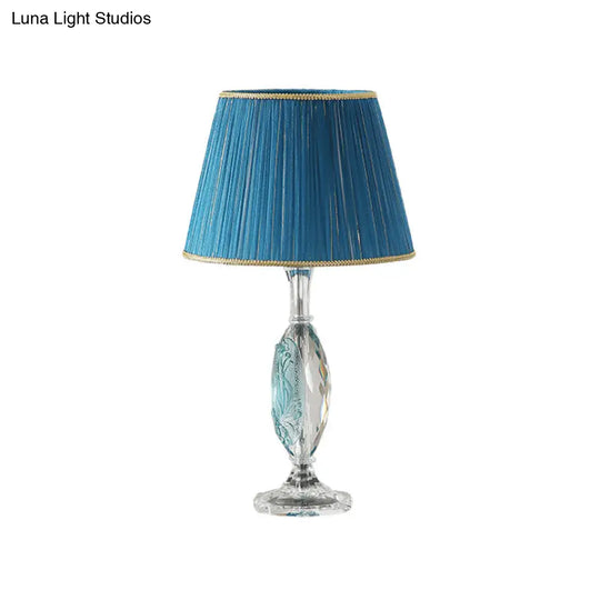 Traditional Clear Crystal Night Light With Blue Fabric Shade And Oblong Base

This Revised Title