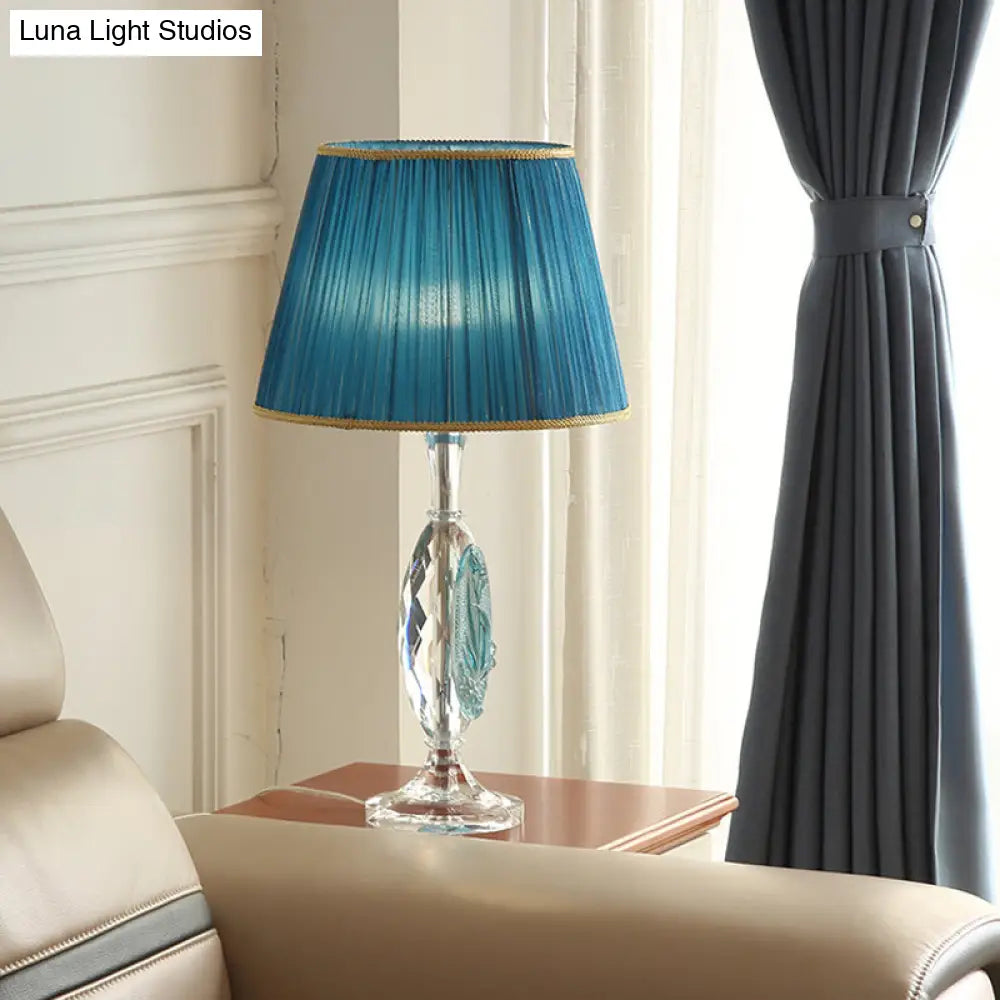 Traditional Clear Crystal Night Light With Blue Fabric Shade And Oblong Base

This Revised Title