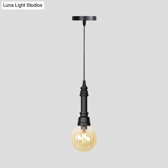 Industrial Black Finish Amber Glass Pendant Lamp With Pipe Suspension - 1-Light Ball/Capsule