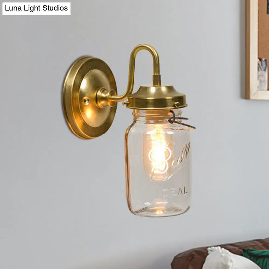 Industrial Clear Glass Wall Sconce With Brass Finish And Letter Detail