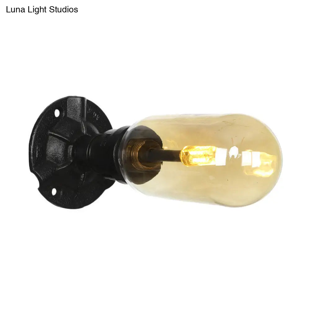 Industrial Dining Room Wall Sconce Lighting Fixture In Black - Amber Glass Capsule With Pipe Design