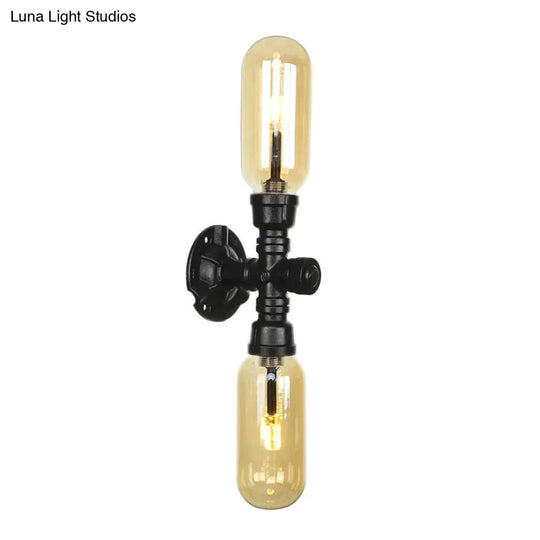 Industrial Dining Room Wall Sconce Lighting Fixture In Black - Amber Glass Capsule With Pipe Design