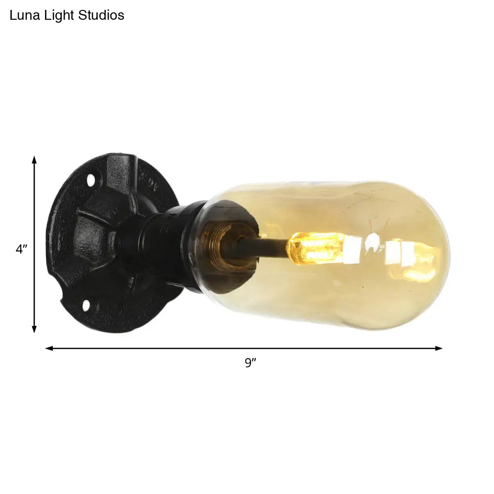 Industrial Dining Room Wall Sconce Lighting Fixture In Black - Amber Glass Capsule With Pipe Design