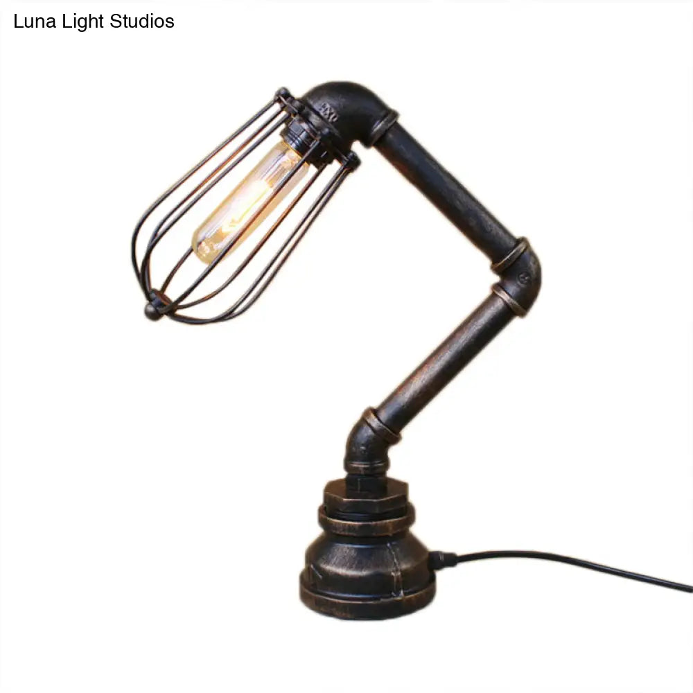 Industrial Style Metal Table Lamp With Bulb Cage Shade & Water Pipe In Aged Bronze