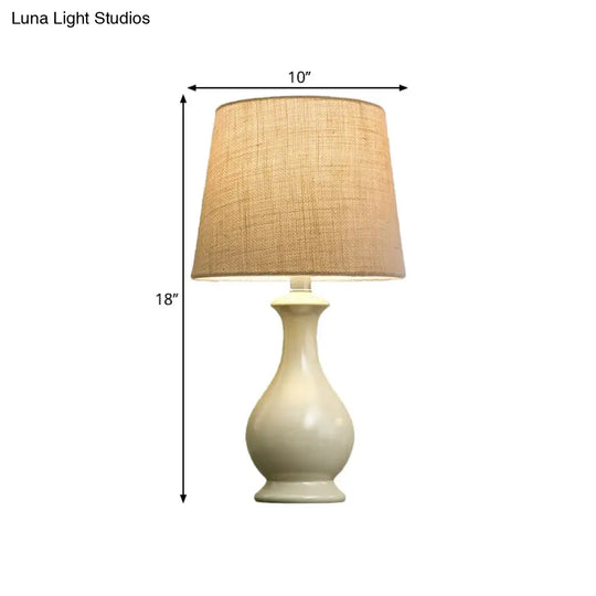 Countryside Beige Fabric Desk Lamp With Conical Bulb And White Vase Base