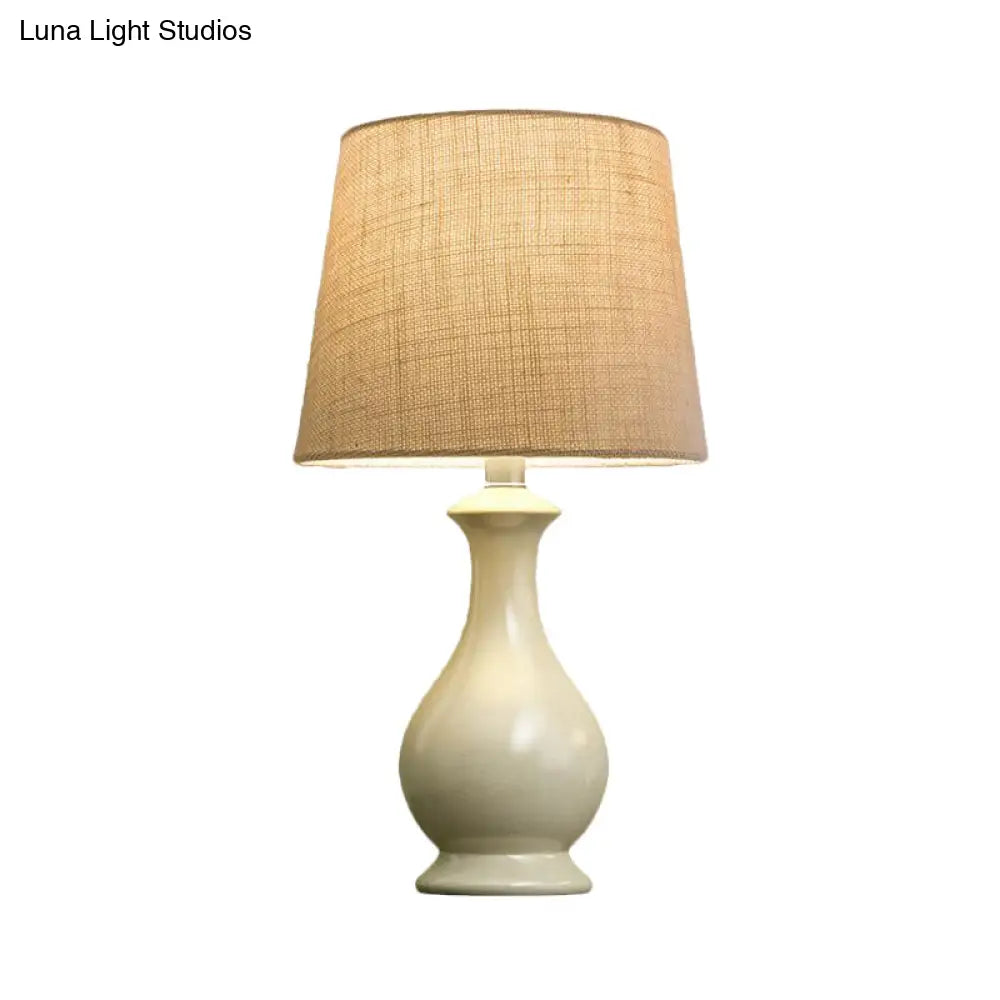 Countryside Beige Fabric Desk Lamp With Conical Bulb And White Vase Base