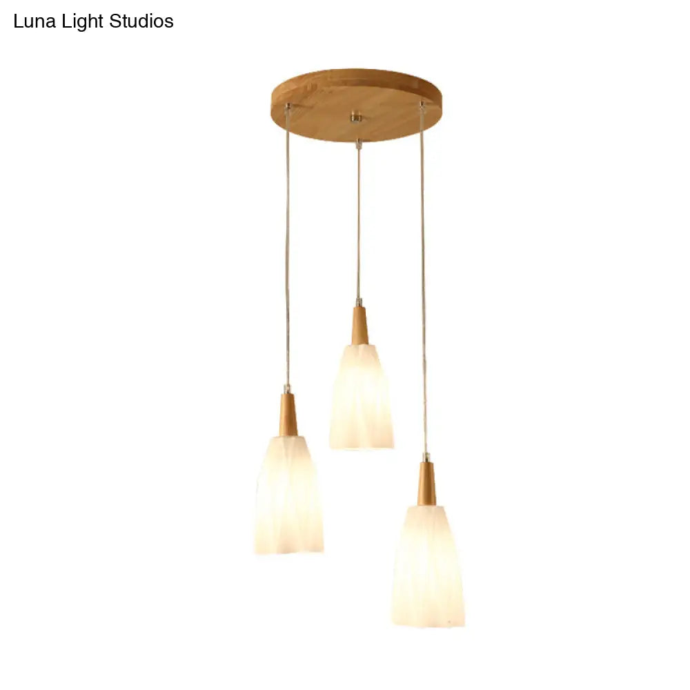 Japanese 3-Light Glass Pendant With Prismatic Cluster In White Hangs From Wood Canopy