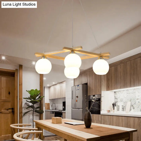 Japanese Style 4-Bulb Cream Glass Sphere Pendant Chandelier For Living Room In Wood