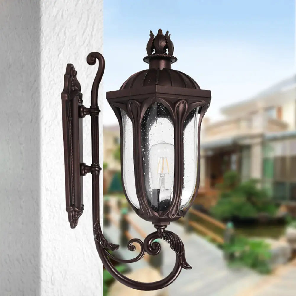 Lodge 1-Head Courtyard Wall Light Fixture With Seedy Glass And Swooping Arm In Dark Coffee