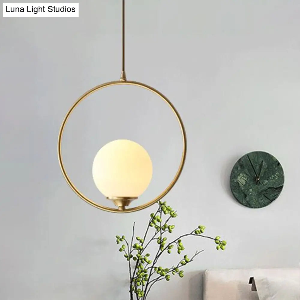 Minimalist Antique Gold Ball Ceiling Lamp With Cream Glass Shade And Ring Decoration