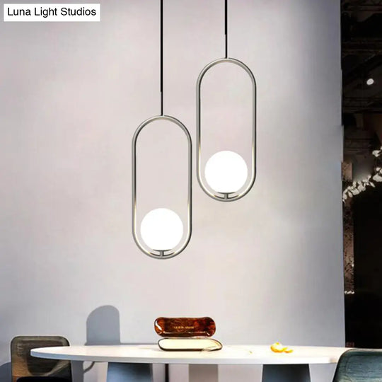 Sleek Chrome Oblong Pendant Light With Minimalist Design And Orb White Glass Shade